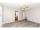 A main bedroom features neutral walls, a ceiling fan, luxury vinyl plank flooring and an ensuite bathroom at 3026 Everbloom Way, Indianapolis, IN 46217