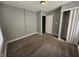 Bedroom featuring plush carpeting, neutral walls, and a closet for organized storage at 3044 Manor Ct, Indianapolis, IN 46218