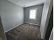 The bedroom includes a window, carpet, and gray walls at 3044 Manor Ct, Indianapolis, IN 46218
