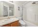 Bright bathroom featuring a shower-tub combination, toilet, and single sink vanity at 3052 Skylar Ln, Indianapolis, IN 46208
