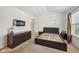 Bright bedroom with carpet and modern fixtures featuring a dark dresser and a modern electric fireplace at 3052 Skylar Ln, Indianapolis, IN 46208