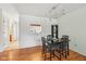 Charming dining area features a black table with seating for four, with wood floors, and a view to the kitchen at 3052 Skylar Ln, Indianapolis, IN 46208