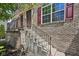 Close up of charming brick townhome entry featuring a brick staircase and large window at 3052 Skylar Ln, Indianapolis, IN 46208