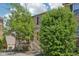 Inviting brick townhome with red shutters, accented by mature trees and landscaping at 3052 Skylar Ln, Indianapolis, IN 46208