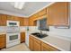 Bright eat-in kitchen featuring ample wood cabinets, modern appliances, and a view through to the dining room at 3052 Skylar Ln, Indianapolis, IN 46208