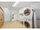 Bright laundry room featuring a stacked washer and dryer with utility sink and ample storage space at 3052 Skylar Ln, Indianapolis, IN 46208