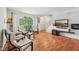 Spacious living room featuring hardwood floors, a large arched window, and modern furnishings at 3052 Skylar Ln, Indianapolis, IN 46208