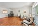 Open-concept living space featuring hardwood floors, modern furniture, and ample natural light at 3052 Skylar Ln, Indianapolis, IN 46208