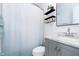 Bathroom with vanity cabinet, shower and decorative shelving at 348 W Stop 11 Rd, Indianapolis, IN 46217