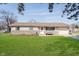 Charming single-story home with a well-manicured lawn, a bench, and an attached garage, perfect for easy living at 348 W Stop 11 Rd, Indianapolis, IN 46217