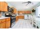 Modern kitchen with stainless steel appliances, wooden cabinets, and a breakfast nook with natural light at 348 W Stop 11 Rd, Indianapolis, IN 46217