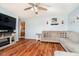 Inviting living room featuring hardwood floors, a sectional sofa, and a view into the adjacent kitchen at 348 W Stop 11 Rd, Indianapolis, IN 46217