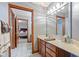 Traditional bathroom with wooden cabinets, framed mirror and access to bedroom at 3608 Olive Branch Rd, Greenwood, IN 46143