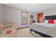 Bedroom featuring a crib, a window with natural light and a dark wood door at 3608 Olive Branch Rd, Greenwood, IN 46143