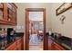 View of the dining room through a butler's pantry with granite countertops at 3608 Olive Branch Rd, Greenwood, IN 46143