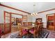 Dining room with hardwood floors, french doors, chandelier, and beautiful decor at 3608 Olive Branch Rd, Greenwood, IN 46143