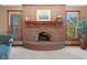 Close-up of a charming brick fireplace with a mantel and decorative accents at 3608 Olive Branch Rd, Greenwood, IN 46143