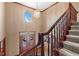 Elegant foyer showcasing a grand staircase, chandelier, and a decorative glass front door at 3608 Olive Branch Rd, Greenwood, IN 46143