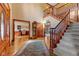 Grand foyer with hardwood floors, staircase, and entrances to the office and living spaces at 3608 Olive Branch Rd, Greenwood, IN 46143