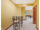 Game room with glass table and chairs leading to another room with games and entertainment at 3608 Olive Branch Rd, Greenwood, IN 46143