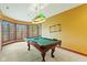 Game room with a pool table and large windows, creates a bright and inviting space at 3608 Olive Branch Rd, Greenwood, IN 46143