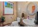 Powder room with a decorative mirror, pedestal sink and tile floors at 3608 Olive Branch Rd, Greenwood, IN 46143