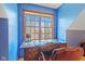 A home office area featuring a wood desk, leather chair and blue wallpaper at 3608 Olive Branch Rd, Greenwood, IN 46143