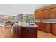 Bright kitchen with an island, granite countertops, wooden cabinetry and hardwood floors at 3608 Olive Branch Rd, Greenwood, IN 46143