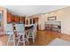 Large kitchen featuring a central island with bar seating, hardwood floors, and ample cabinet space at 3608 Olive Branch Rd, Greenwood, IN 46143