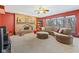 Inviting living room with a brick fireplace and large windows, providing a cozy and bright atmosphere at 3608 Olive Branch Rd, Greenwood, IN 46143