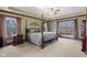 Spacious main bedroom boasts a four-poster bed, multiple windows, and neutral decor at 3608 Olive Branch Rd, Greenwood, IN 46143