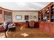 Spacious office with wood-paneled walls, built-in bookshelves, and a large window at 3608 Olive Branch Rd, Greenwood, IN 46143
