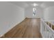 Bright attic space with hardwood floors, white walls and trim, illuminated by a window offering natural light at 3905 N Drexel Ave, Indianapolis, IN 46226