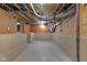 Unfinished basement with exposed pipes, concrete walls and floor, and plenty of space for storage at 3905 N Drexel Ave, Indianapolis, IN 46226