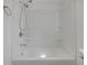 Clean white bathtub and shower combination with chrome fixtures and built in shelving at 3905 N Drexel Ave, Indianapolis, IN 46226
