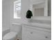 Bright bathroom featuring a toilet, white vanity, and a shower/bath combo, with natural light at 3905 N Drexel Ave, Indianapolis, IN 46226