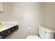 Modest bathroom featuring a single sink vanity and toilet at 4013 Priscilla Ave, Indianapolis, IN 46226