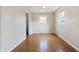 Clean, uncluttered room with parquet flooring, neutral walls and abundant natural light for various uses at 4013 Priscilla Ave, Indianapolis, IN 46226