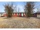 Modest brick home with a symmetrical facade and a welcoming front entrance, framed by bare trees at 4013 Priscilla Ave, Indianapolis, IN 46226