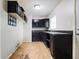 A dated kitchen with black cabinets and plenty of room for modernization at 4013 Priscilla Ave, Indianapolis, IN 46226