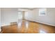 Bright, airy living room with pristine white walls and classic parquet wood flooring, awaiting personal touches at 4013 Priscilla Ave, Indianapolis, IN 46226