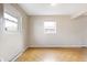 Bright living room featuring hardwood floors and two windows allowing natural light at 4013 Priscilla Ave, Indianapolis, IN 46226