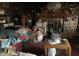 A crowded living room filled with furniture, books, and various decorative items on shelves and surfaces at 4718 W 36Th St, Indianapolis, IN 46222