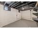 Unfinished basement with painted concrete walls and exposed ceiling at 516 N Chester Ave, Indianapolis, IN 46201