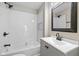 Stylish bathroom with white subway tile in shower/tub, gray vanity, and updated fixtures at 516 N Chester Ave, Indianapolis, IN 46201