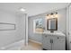 Modern bathroom featuring a tub, shower, and a stylish vanity with a sleek mirror and lighting at 516 N Chester Ave, Indianapolis, IN 46201