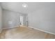 Neutral bedroom with laminate flooring, light gray walls, and ample natural light at 516 N Chester Ave, Indianapolis, IN 46201