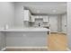 Bright kitchen featuring white cabinets and countertops and stainless steel hardware at 516 N Chester Ave, Indianapolis, IN 46201