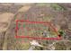 Aerial view of a large property with mature trees, outlined in red, showcasing the expansive landscape and home at 534 1/2 Amos Dr, Zionsville, IN 46077