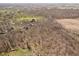 The aerial shot reveals the house surrounded by a vast area of trees, with town in the background at 534 1/2 Amos Dr, Zionsville, IN 46077